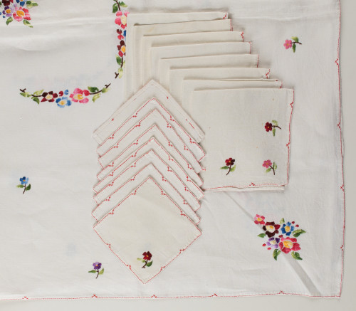 White thread tablecloth with polychrome embroidered flowers