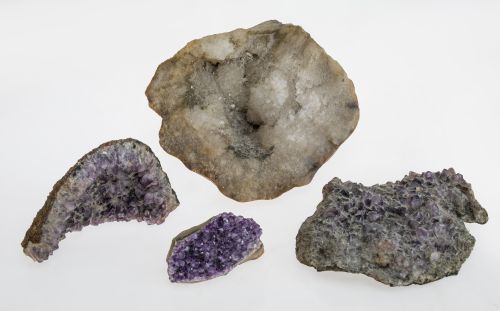 Lot consisting of three amethyst geodes and one white quart