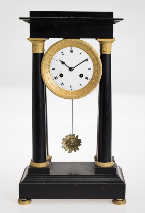 Portico-type table clock in black marble and gilded bronze,