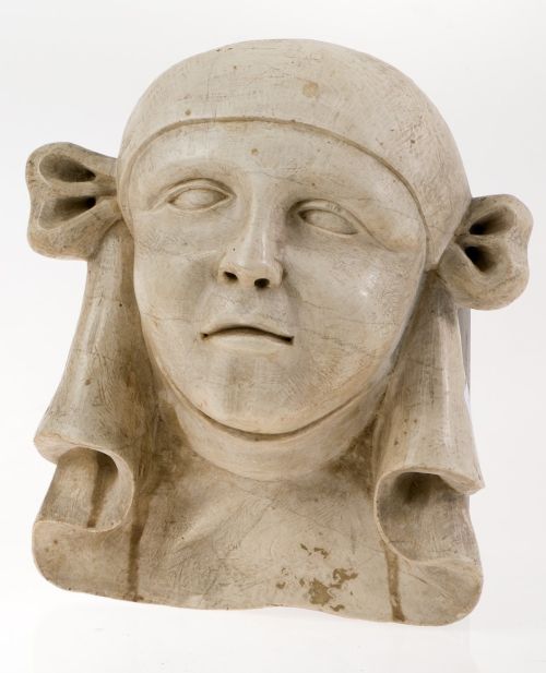 "Face". Fragment of a cornice from a façade in pressed ston